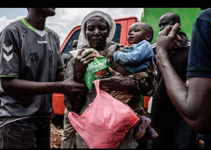 A mother receiving food relief supplies