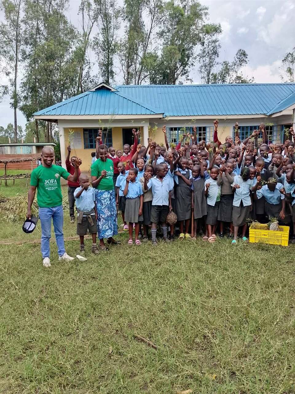 JOFA Green Action volunteers with schoolchildren celebrating a tree-planting day at a primary school
