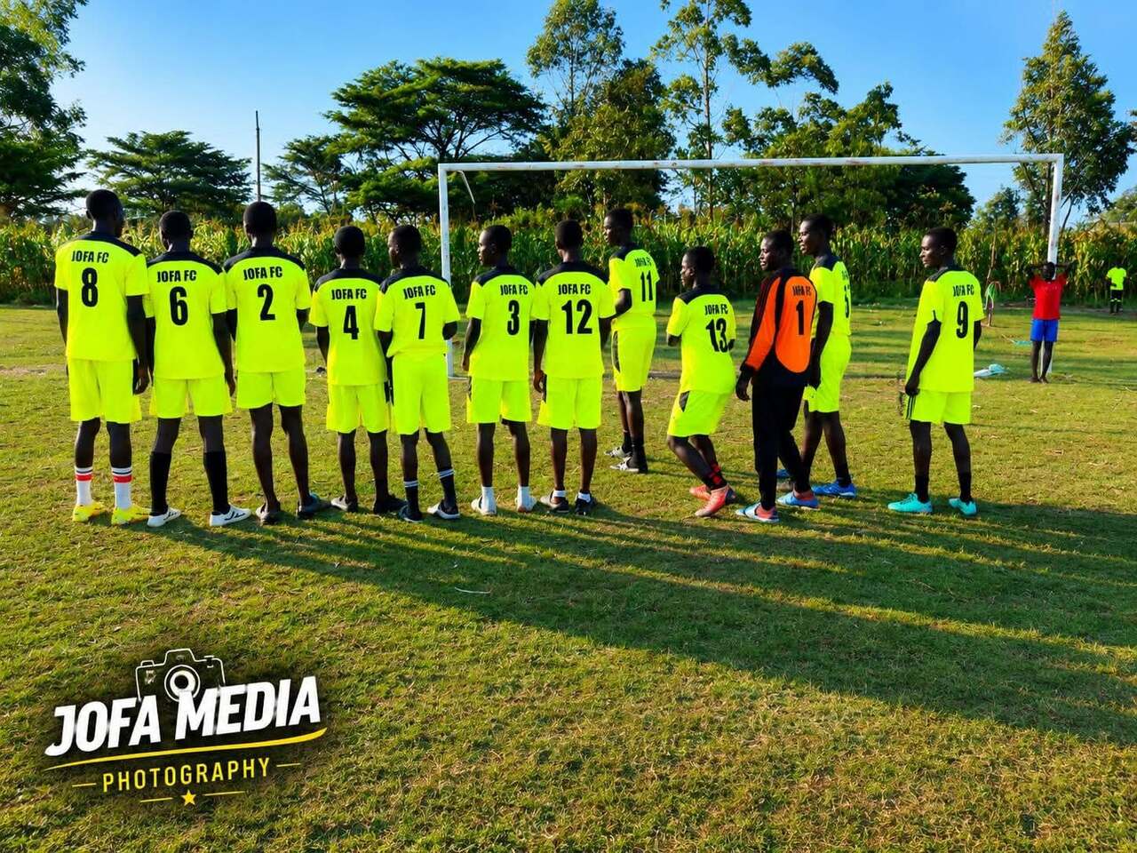 JOFA FC youth football team lined up on the pitch before a match
